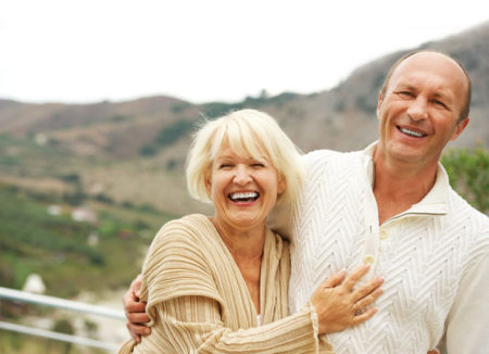 photo of a smiling woman and man, embracing and laughing