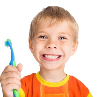 Smiling boy with toothbrush