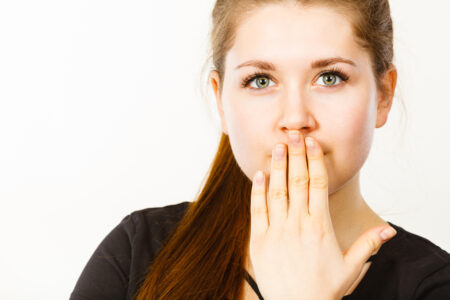 woman covering her mouth